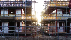 Scaffolding on new-build houses under construction, representing the rejected New Town plans.
