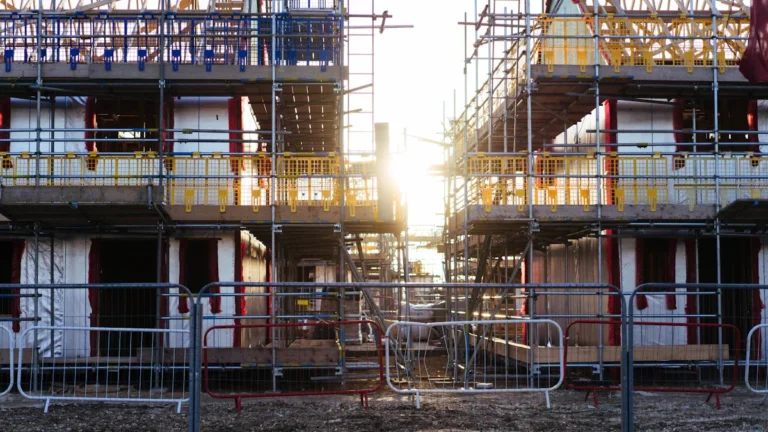 Scaffolding on new-build houses under construction, representing the rejected New Town plans.