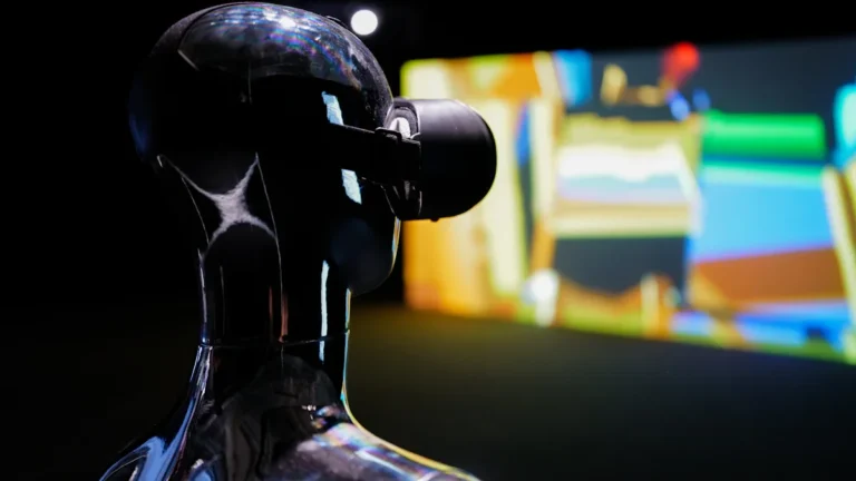 A sleek robot-like mannequin wearing a virtual reality headset against a dark background.