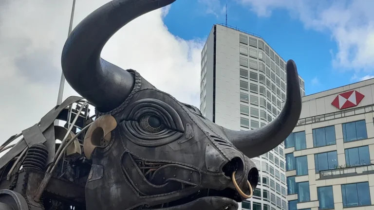 A close-up of the mechanical 'Bab the Bull' sculpture against the Birmingham city skyline for the 100-day athletics countdown.