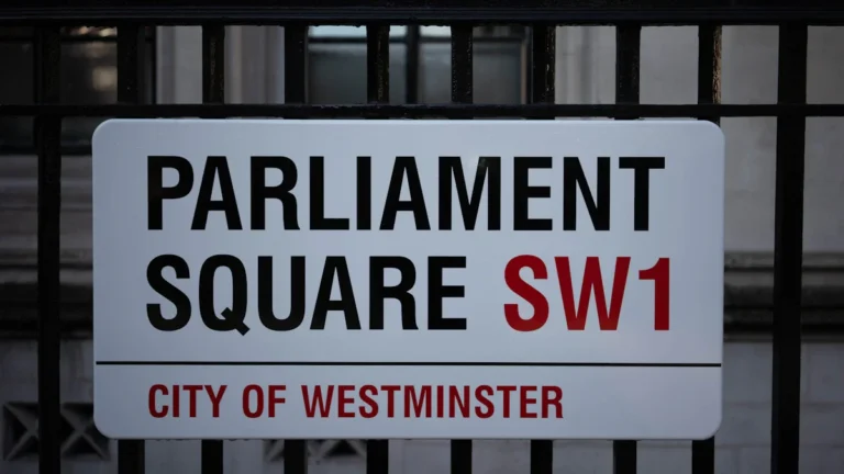 A sign for Parliament Square SW1 in the City of Westminster, London, representing the center of UK political activity.