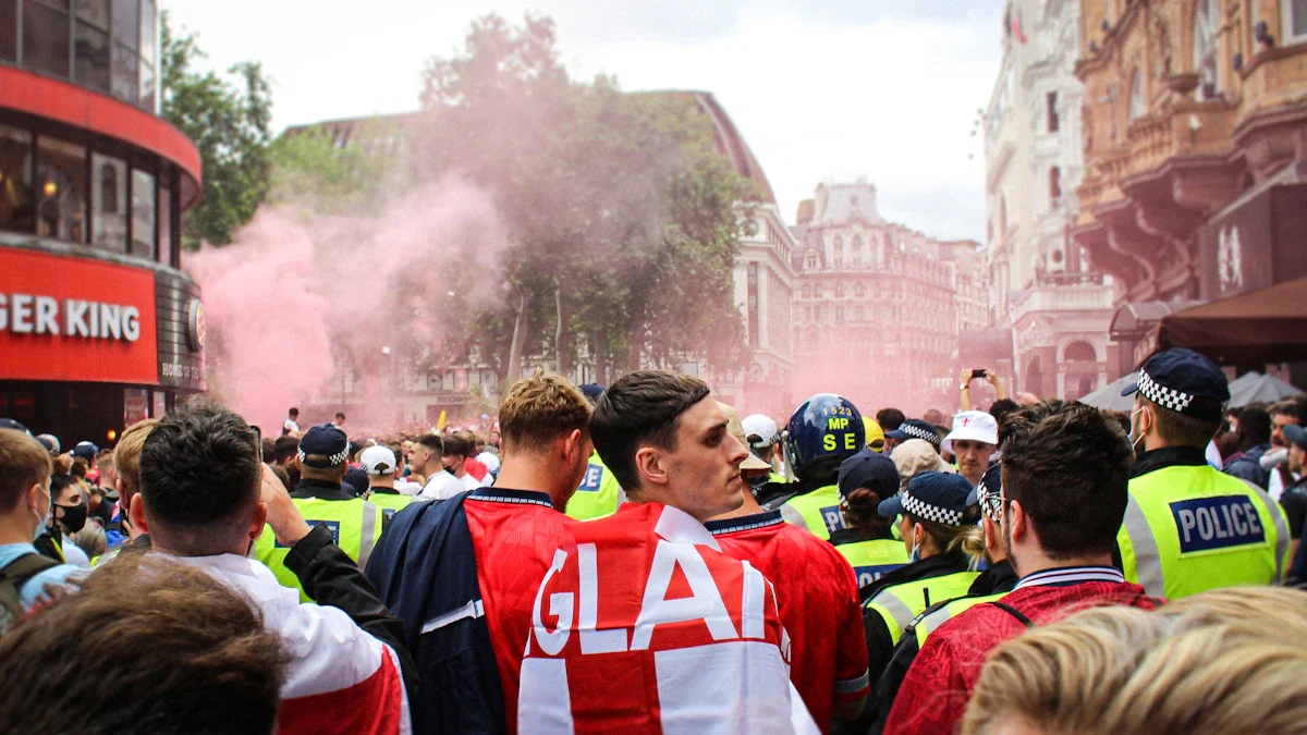 England football fans in red and white jerseys gathering on a London street.