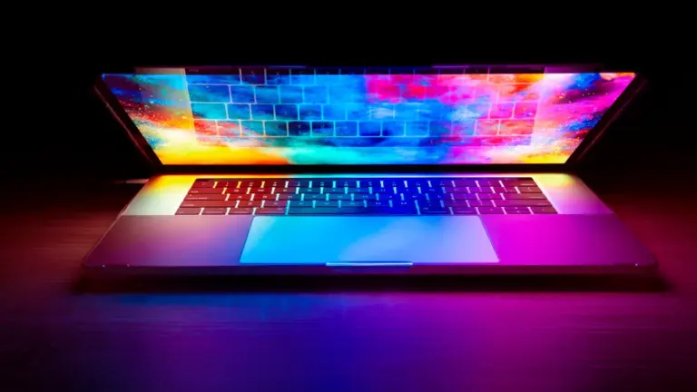 A high-performance gaming laptop with vibrant, colorful screen display and lighting effects.