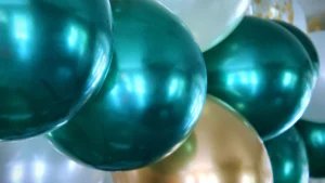Close-up of green and gold balloons celebrating a political victory.