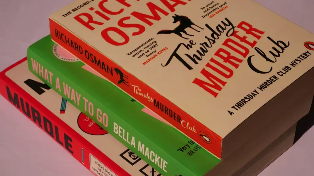 Three crime and mystery novels stacked on a clean white surface.