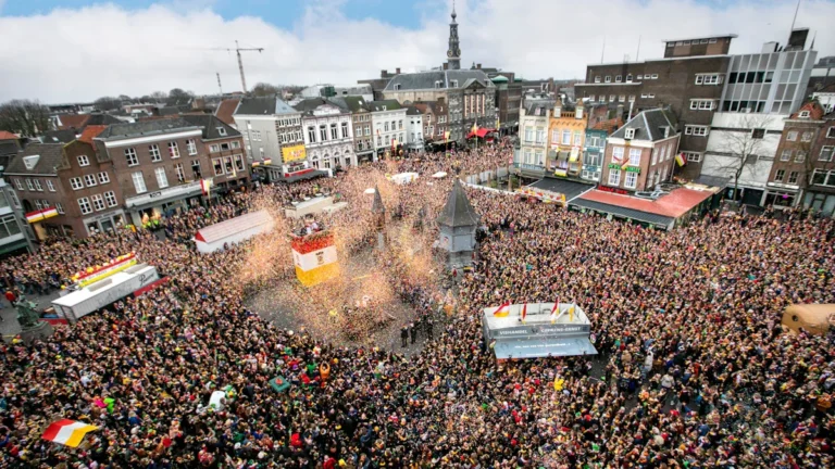 High-angle view of a densely crowded city square during a large-scale public celebration and parade.