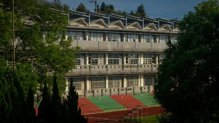 A multi-story school building with a sports field, representing the educational infrastructure under review in Limbaži Municipality.
