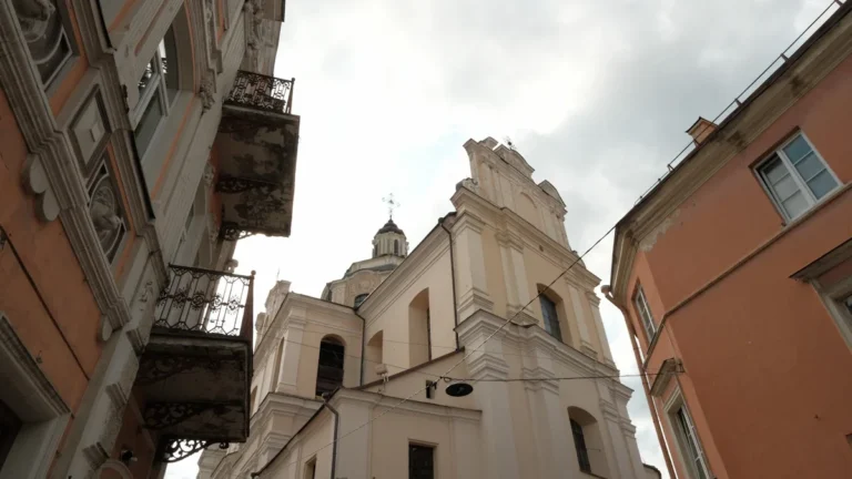Low-angle view of the historic St. Johns Church tower and surrounding heritage buildings in Vilnius.