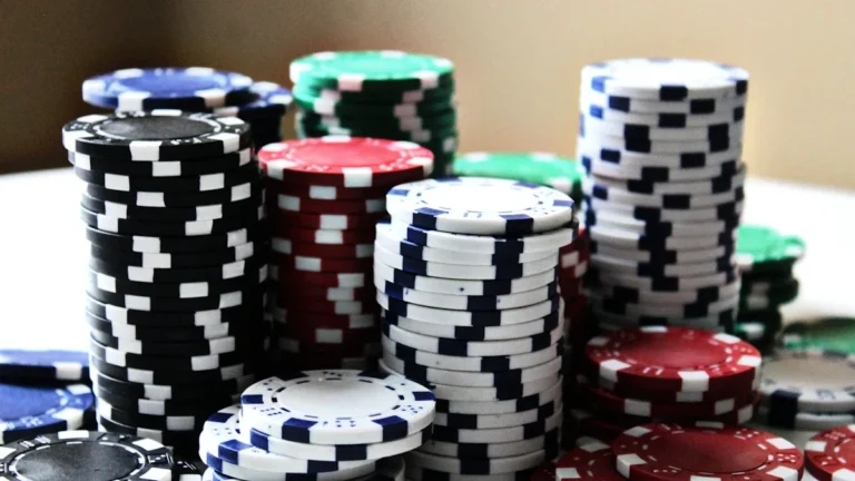 Several tall, organized stacks of multi-colored poker chips representing significant financial revenue and growth.