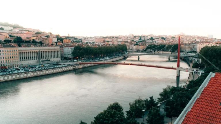 A panoramic daytime view of the Saône river flowing through the historic city of Lyon, France.