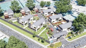 An aerial view of a contemporary housing development featuring modern white buildings and green communal spaces.