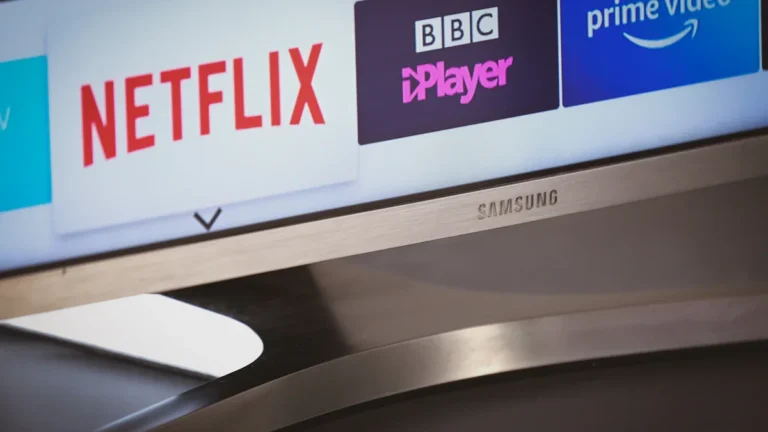 A close-up of a Samsung Smart TV screen displaying streaming apps like Netflix and BBC iPlayer.