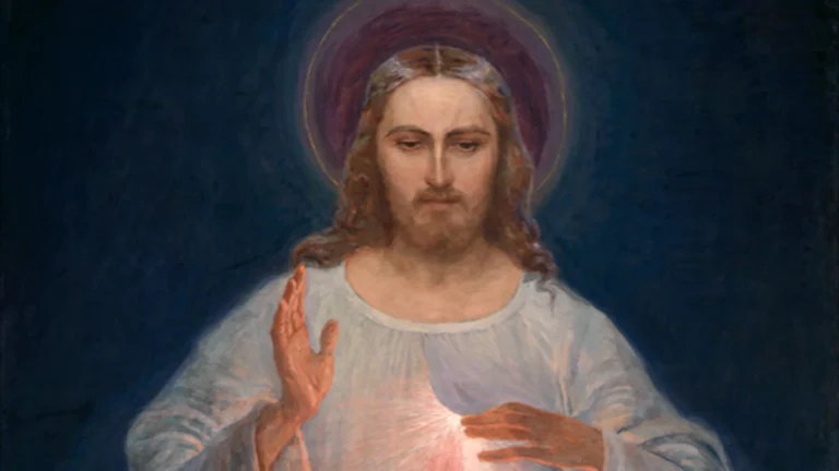 Classical painting of Jesus Christ with a halo, raising his hand and radiating light from heart.