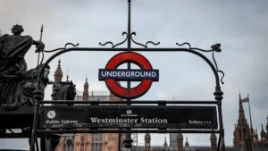 Westminster Underground Station sign with the Houses of Parliament in the background