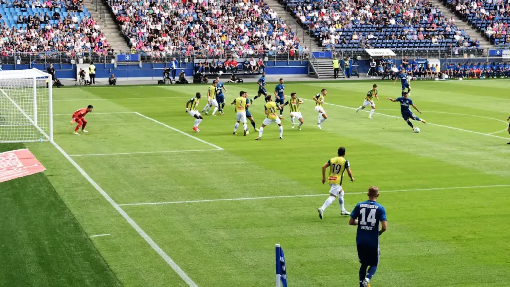 Professional soccer players competing on a grassy field during a competitive match.