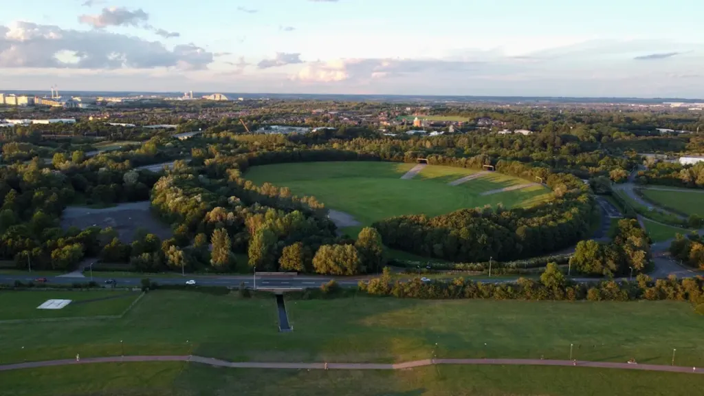 Aerial view of the National Bowl in Milton Keynes during a golden sunset.