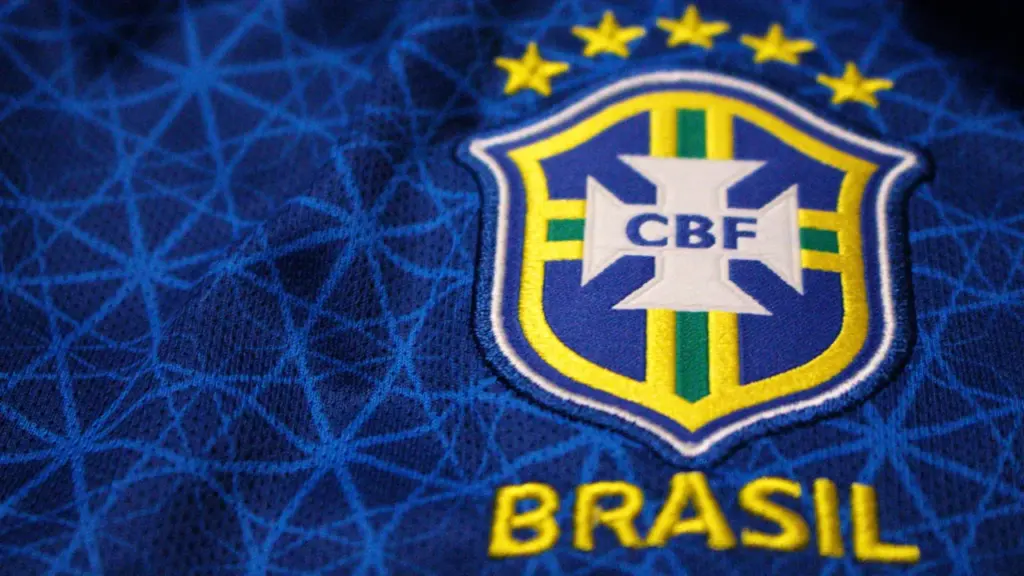 Close-up of the Brazil football team crest embroidered on a blue jersey.