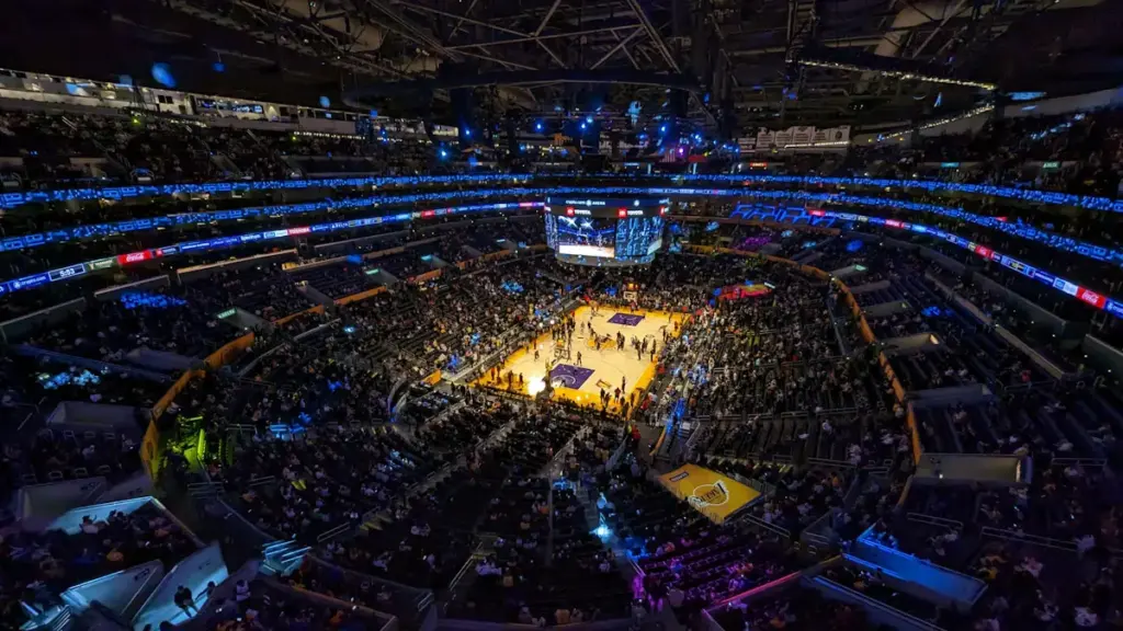 High angle view of a professional basketball arena court with seating.