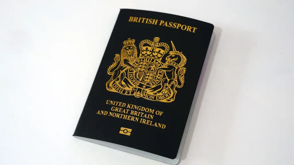 A close-up studio shot of a modern blue British passport on white.