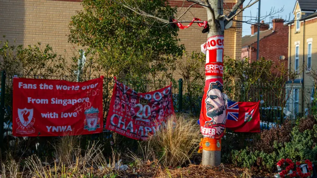 Liverpool FC fan tributes left on a tree outside Anfield stadium.